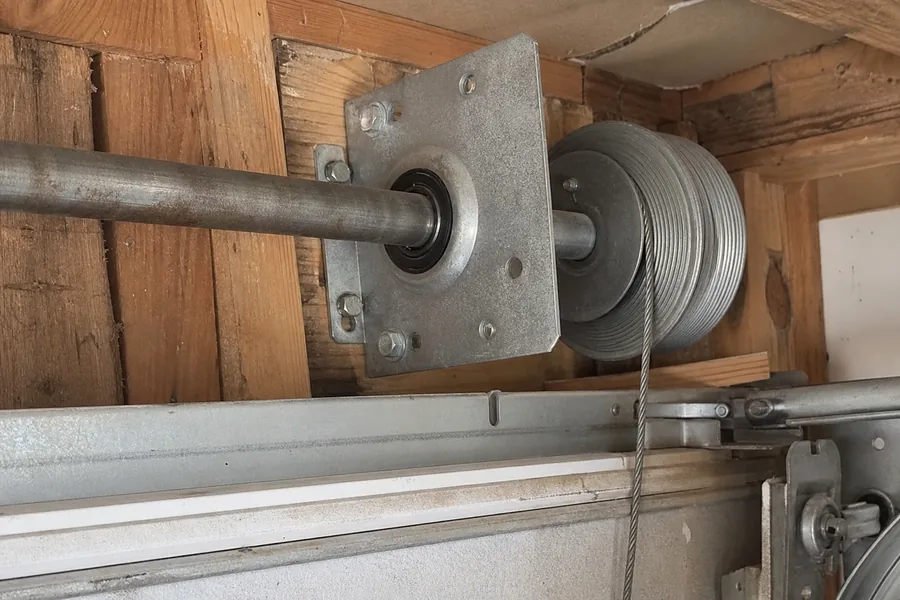 End bearing plate and cable drum above a garage door in Pueblo, CO
