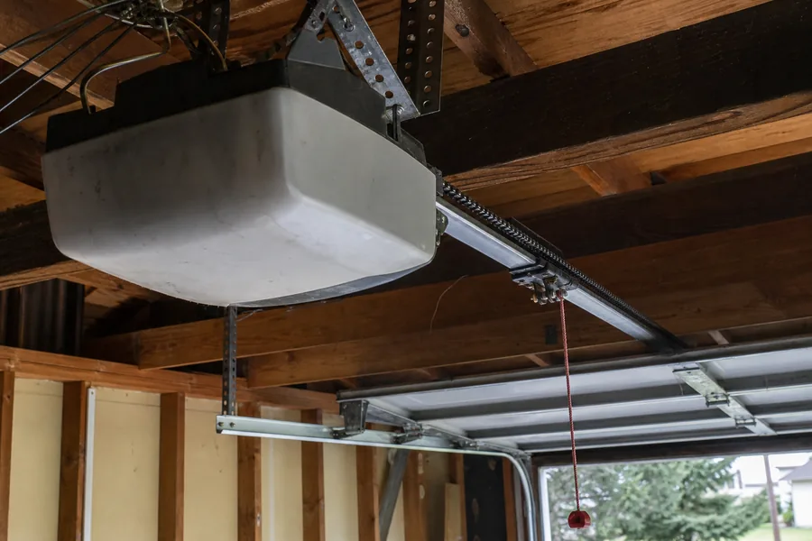 Opener and rail above the attached garage of a stucco ranch