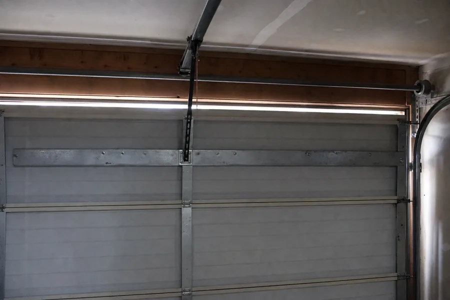 Reinforcement strut across the top panel of a double garage door in Pueblo, CO