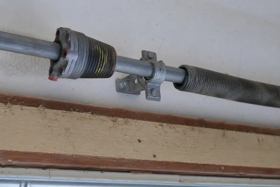 Torsion spring, winding cone and center bearing above a garage door in Pueblo, CO